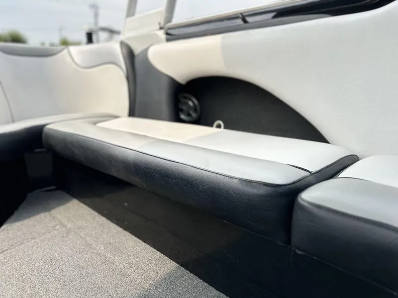 Slide: The Image of Interior seating of 2016 Sanger 237LTZ boat, featuring sleek black and white upholstery. - 14