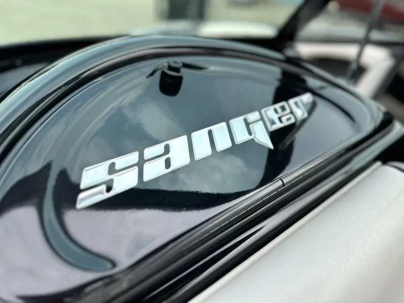 Slide: The Image of Close-up of 2016 Sanger 237LTZ boat logo on black surface. - 19