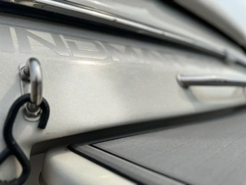 Slide: The Image of Close-up of a 2016 Sanger 237LTZ boat detail, featuring metal hardware and sleek design. - 20