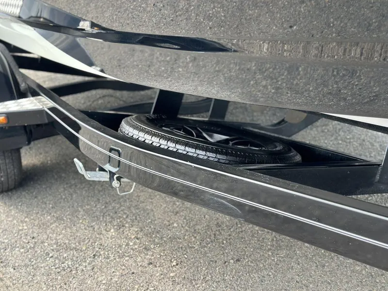 Slide: The Image of 2016 Sanger 237LTZ boat trailer with spare tire on asphalt. - 21
