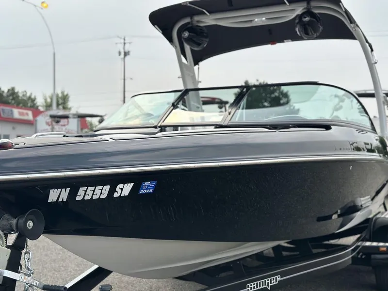 Slide: The Image of 2016 Sanger 237LTZ boat on trailer, black exterior, registration number visible. - 5