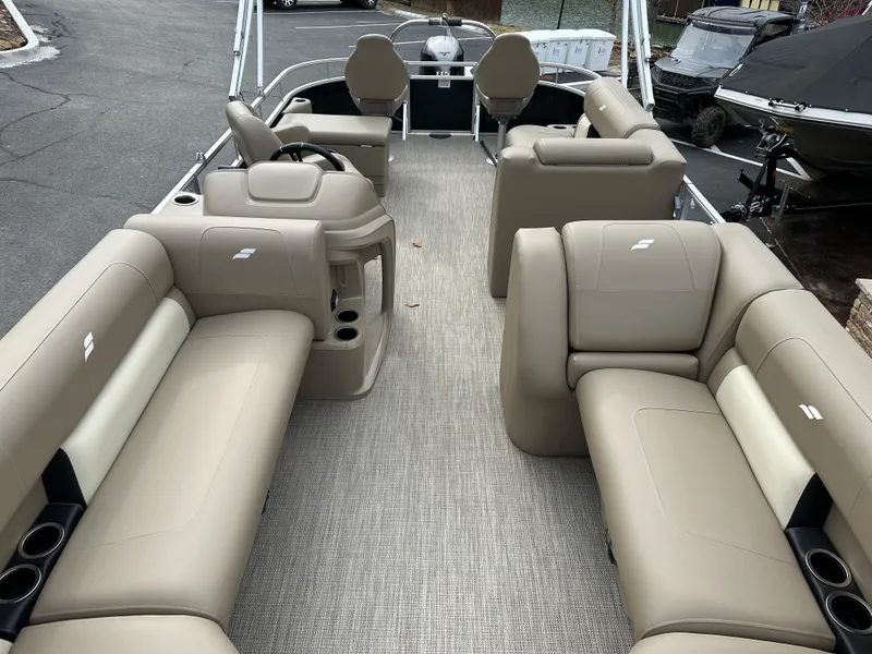 Slide: The Image of 2024 Starcraft LX 22 F pontoon boat with spacious beige seating and modern design. - 10