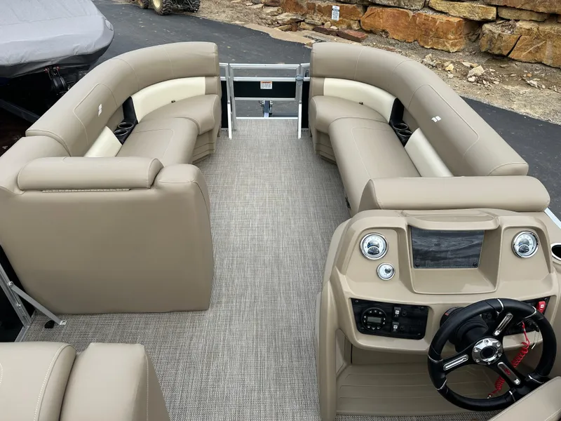 Slide: The Image of 2024 Starcraft LX 22 F boat interior with beige seating and modern dashboard. - 11