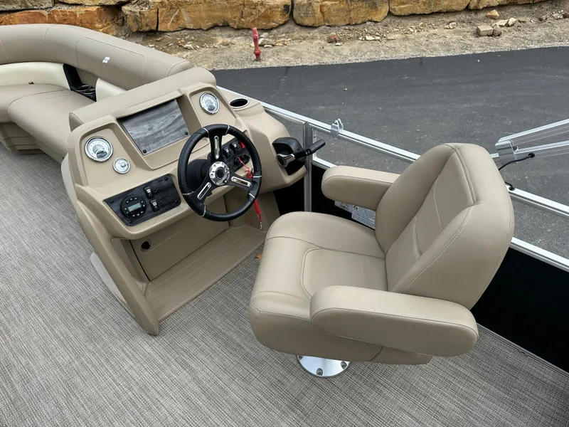 Slide: The Image of 2024 Starcraft LX 22 F boat interior with beige captain's chair and modern dashboard. - 14