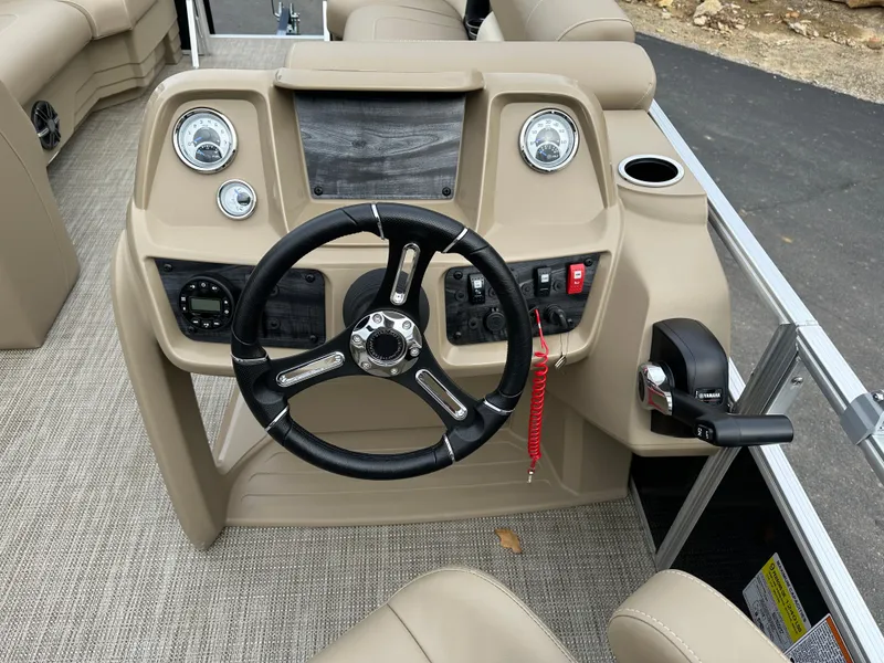Slide: The Image of 2024 Starcraft LX 22 F boat dashboard with steering wheel and controls. - 15