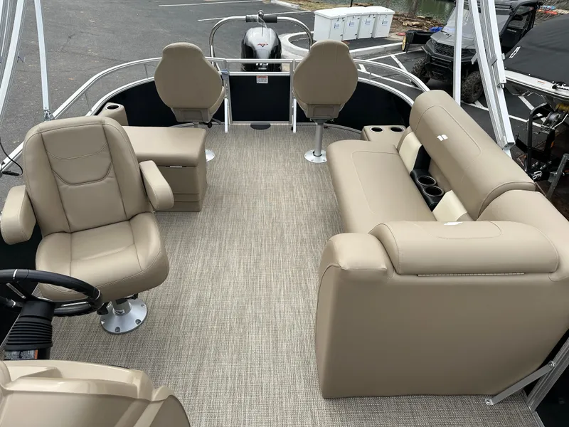 Slide: The Image of 2024 Starcraft LX 22 F pontoon boat interior with beige seating and steering console. - 17
