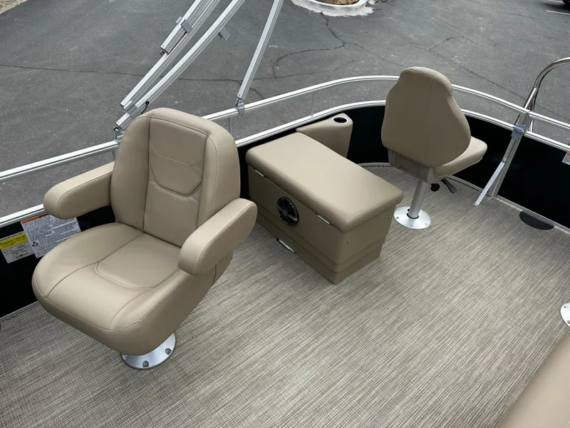 Slide: The Image of 2024 Starcraft LX 22 F boat interior with beige seating and carpeted flooring. - 18