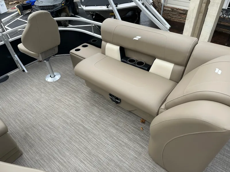 Slide: The Image of 2024 Starcraft LX 22 F boat interior with beige seating and cup holders. - 19