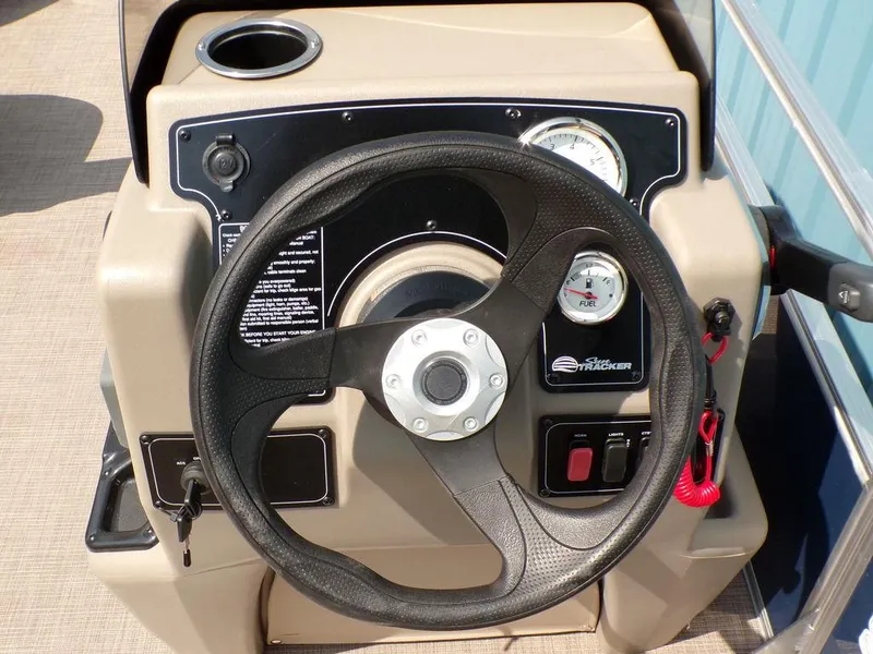 Slide: The Image of 2024 Sun Tracker BASS BUGGY® 18 DLX steering console with gauges and controls. - 11