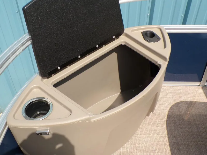 Slide: The Image of 2024 Sun Tracker BASS BUGGY® 18 DLX storage compartment with cup holders and open lid. - 12