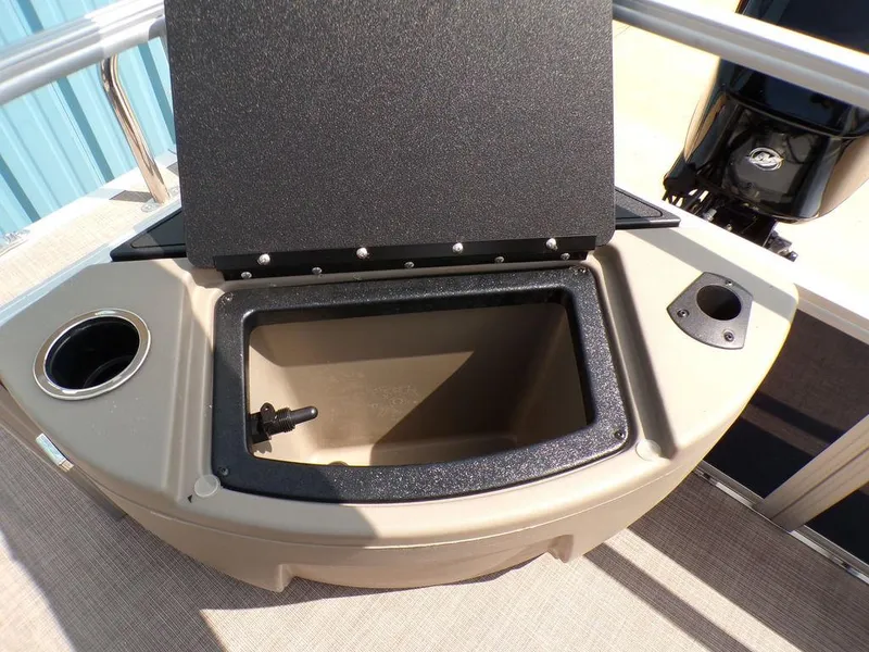 Slide: The Image of 2024 Sun Tracker BASS BUGGY® 18 DLX boat storage compartment with cup holder and motor view. - 18