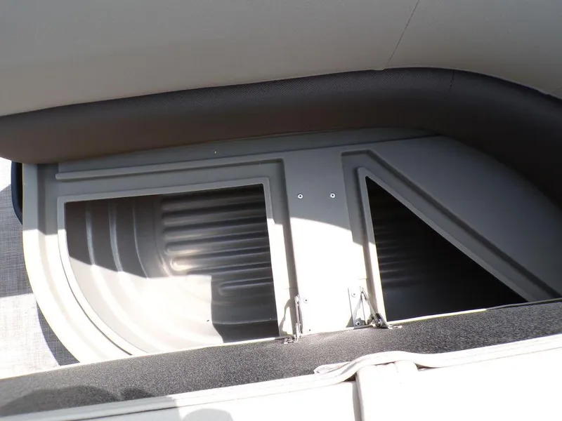 Slide: The Image of 2024 Sun Tracker BASS BUGGY® 18 DLX storage compartment with open lid, showcasing interior space. - 19