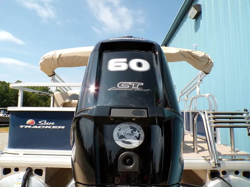 Slide: The Image of 2024 Sun Tracker BASS BUGGY® 18 DLX with 60 HP engine, docked near blue building. - 7