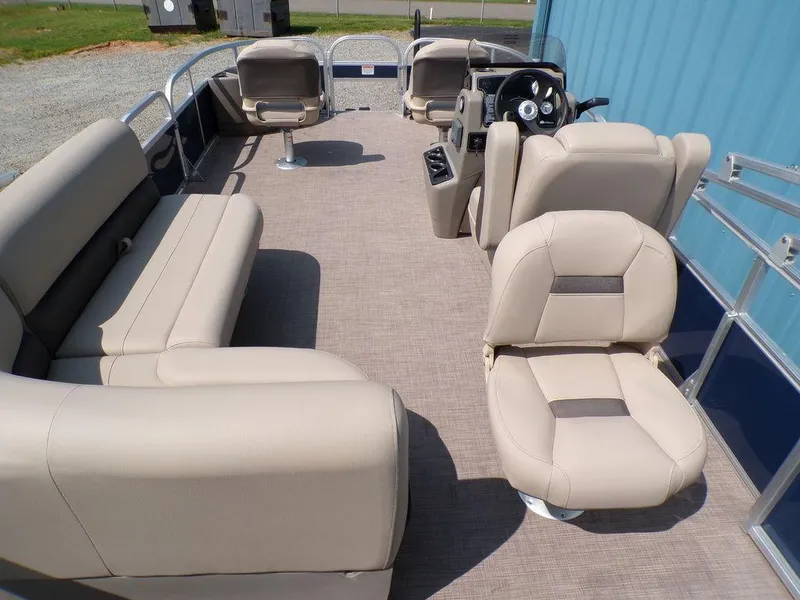Slide: The Image of 2024 Sun Tracker BASS BUGGY® 18 DLX pontoon boat interior with beige seating. - 8