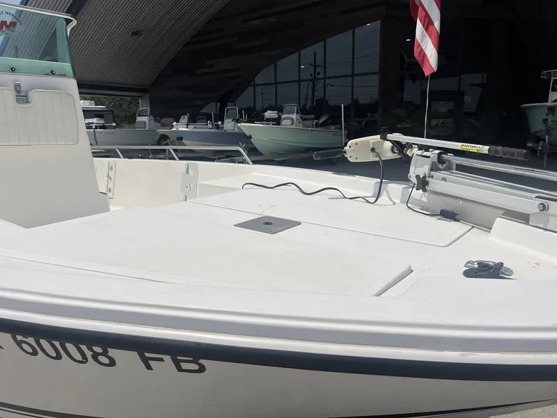 Slide: The Image of 2000 Robalo 2000 boat with American flag, displayed in a showroom. - 10