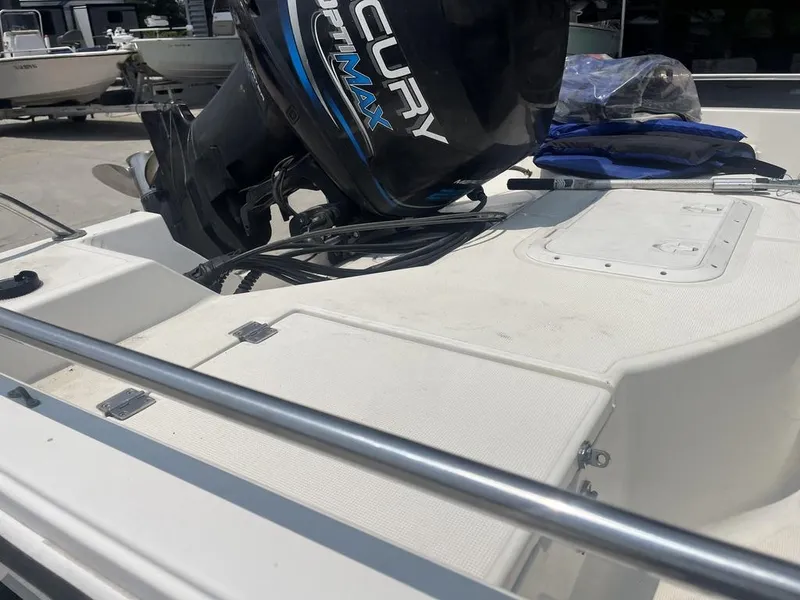 Slide: The Image of Robalo 2000 boat with Mercury OptiMax engine, docked outdoors. - 13
