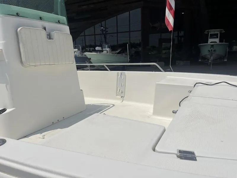 Slide: The Image of Robalo 2000 boat interior, showcasing seating and storage, with an American flag in the background. - 17