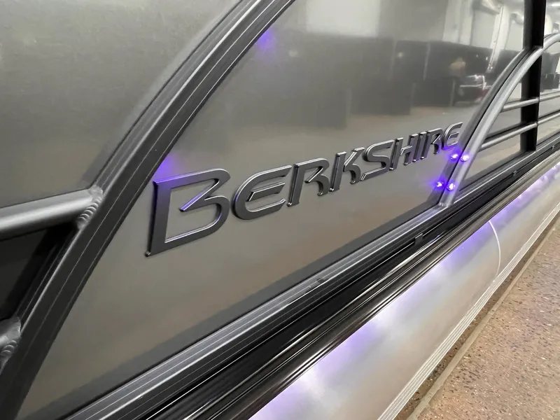 Slide: The Image of 2025 Berkshire 25RFX Roswell Arch STS Tritoon with illuminated logo detail. - 11