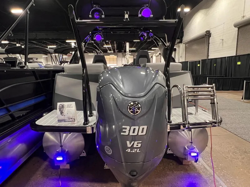 Slide: The Image of 2025 Berkshire 25RFX Roswell Arch STS Tritoon with powerful 300 V6 engine displayed indoors. - 16