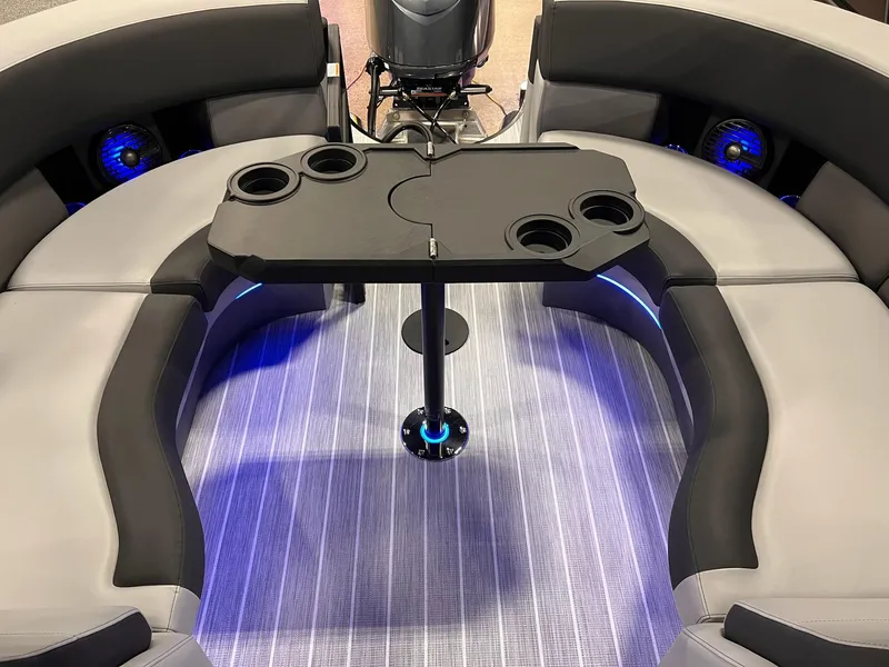 Slide: The Image of 2025 Berkshire 25RFX Roswell Arch STS Tritoon interior with sleek seating and modern table design. - 17