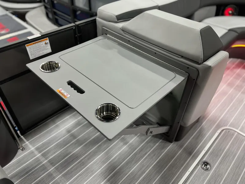 Slide: The Image of 2025 Berkshire 25RFX Roswell Arch STS Tritoon interior with foldable table and cup holders. - 18