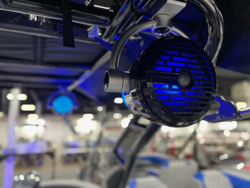 Slide: The Image of Close-up of Roswell speaker on 2025 Berkshire 25RFX Roswell Arch STS Tritoon, illuminated in blue. - 21