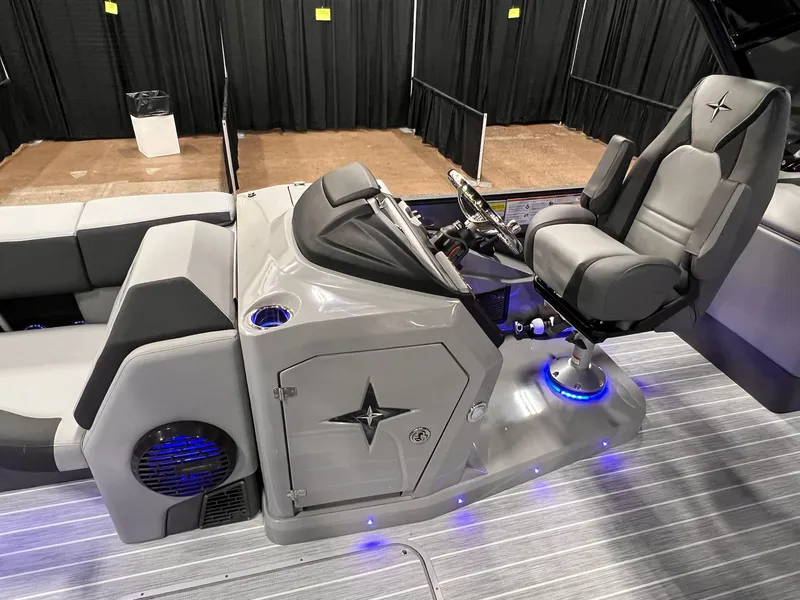 Slide: The Image of 2025 Berkshire 25RFX Roswell Arch STS Tritoon helm with modern seating and illuminated controls. - 28