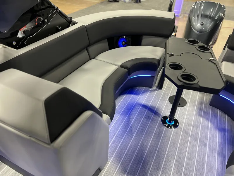 Slide: The Image of Luxurious seating area on 2025 Berkshire 25RFX Roswell Arch STS Tritoon with modern table and cup holders. - 30