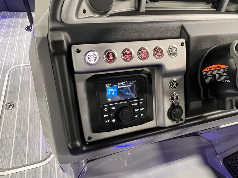 Slide: The Image of Control panel of 2025 Berkshire 25RFX Roswell Arch STS Tritoon with audio system and switches. - 5