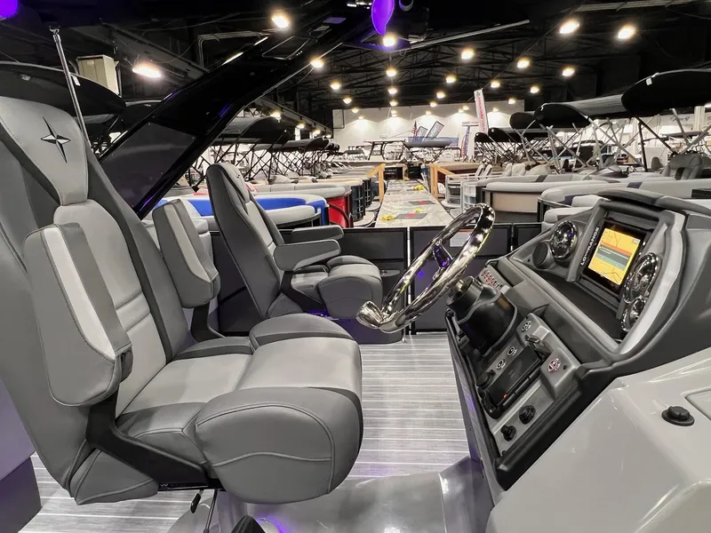 Slide: The Image of 2025 Berkshire 25RFX Roswell Arch STS Tritoon interior with modern dashboard and seating. - 7