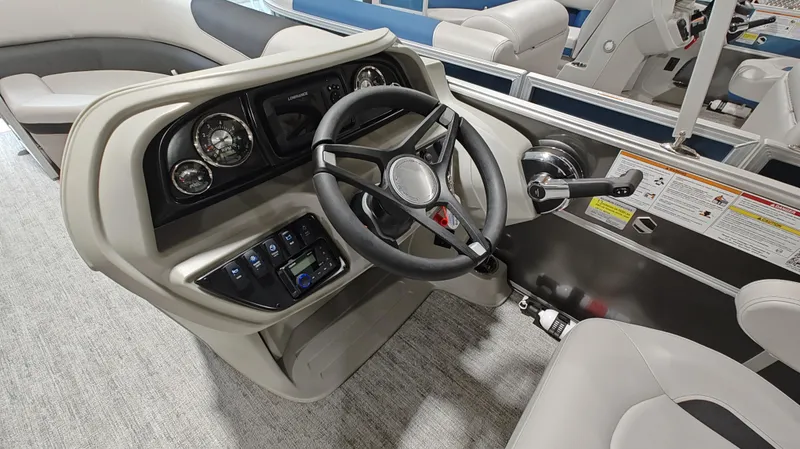Slide: The Image of 2024 South Bay 224RS LE 2.75 boat dashboard with steering wheel and controls. - 11