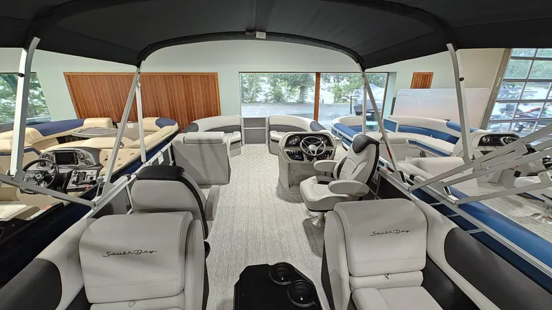 Slide: The Image of 2024 South Bay 224RS LE 2.75 pontoon boat interior with luxurious seating and modern dashboard. - 4