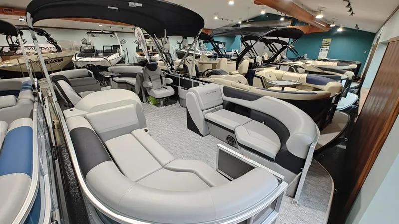 Slide: The Image of 2024 South Bay 224RS LE 2.75 pontoon boats displayed in showroom. - 5