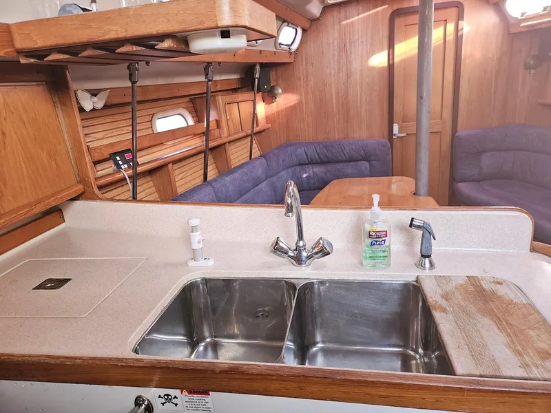 Slide: The Image of Interior of a Catalina 380 yacht with kitchen and seating area. - 10
