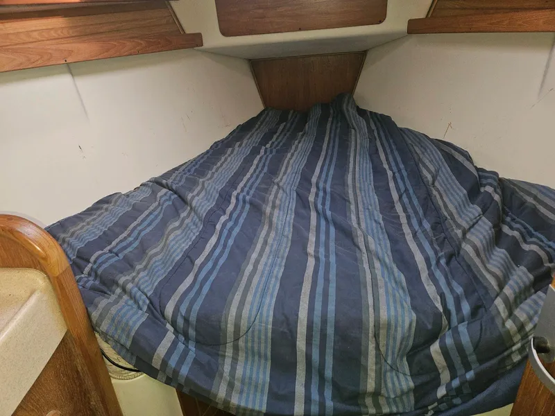 Slide: The Image of Cabin of a Catalina 380 yacht with striped bedding. - 20