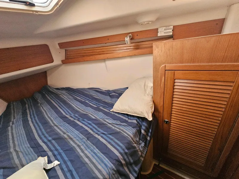 Slide: The Image of Interior of a 2000 Catalina 380 yacht with cozy bed. - 21