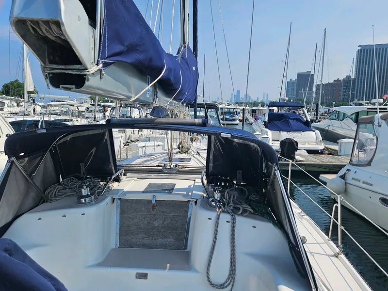 Slide: The Image of 2000 Catalina 380 sailboat docked in marina with city skyline. - 7