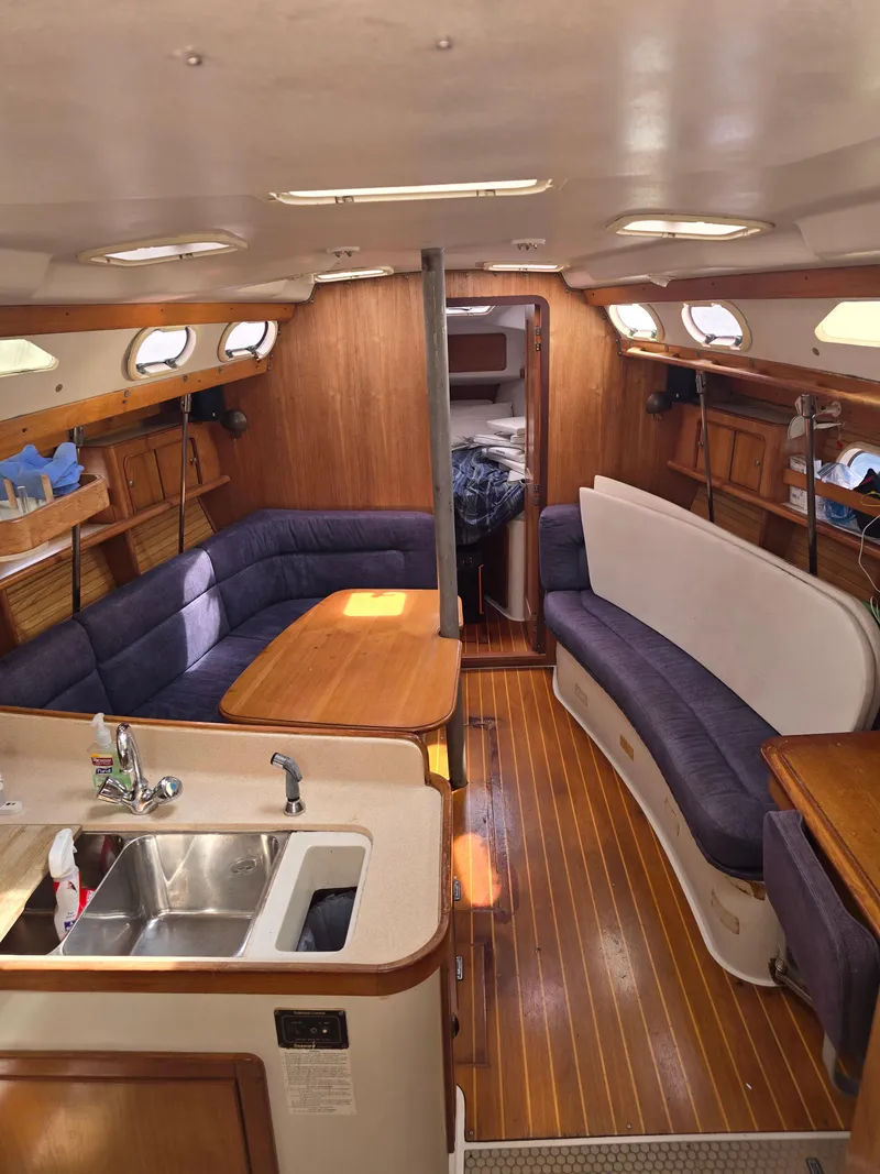 Slide: The Image of Interior of a 2000 Catalina 380 yacht with wooden furnishings. - 9