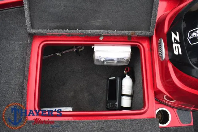 Slide: The Image of 2014 Nitro Z Series Z-6 storage compartment with equipment and fire extinguisher. - 16