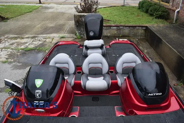 Slide: The Image of 2014 Nitro Z Series Z-6 boat with dual engines and seating, parked outdoors. - 17