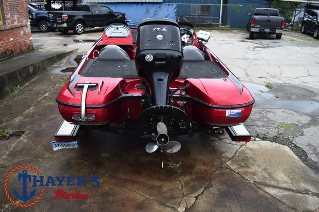 Slide: The Image of Red 2014 Nitro Z Series Z-6 boat with outboard motor, parked on concrete. - 9