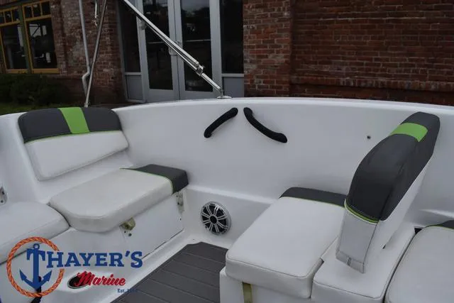 Slide: The Image of 2022 Tahoe T16 boat interior with cushioned seating and Thayer's Marine logo. - 20