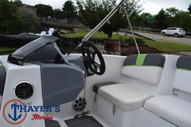 Slide: The Image of 2022 Tahoe T16 boat interior with steering wheel and seating, Thayer's Marine logo visible. - 22
