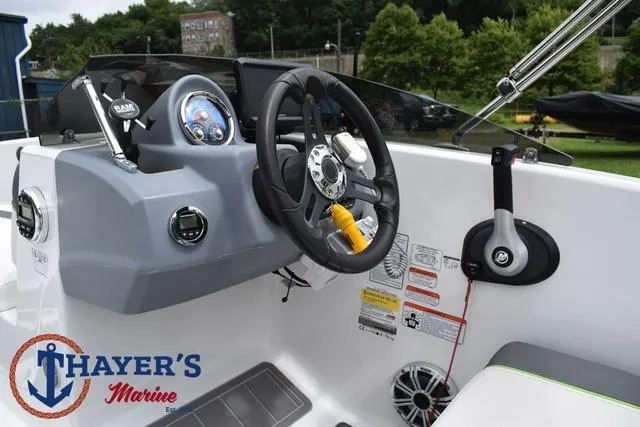 Slide: The Image of 2022 Tahoe T16 boat dashboard with steering wheel and controls at Thayer's Marine. - 25