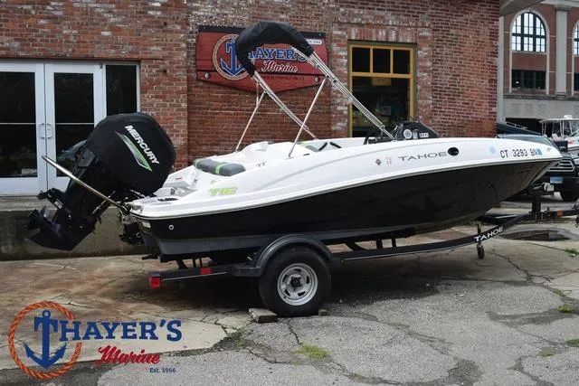 Slide: The Image of 2022 Tahoe T16 boat on trailer outside Thayer's Marine shop. - 3