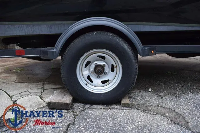 Slide: The Image of Tahoe T16 2022 trailer wheel on blocks, Thayer's Marine logo visible. - 7