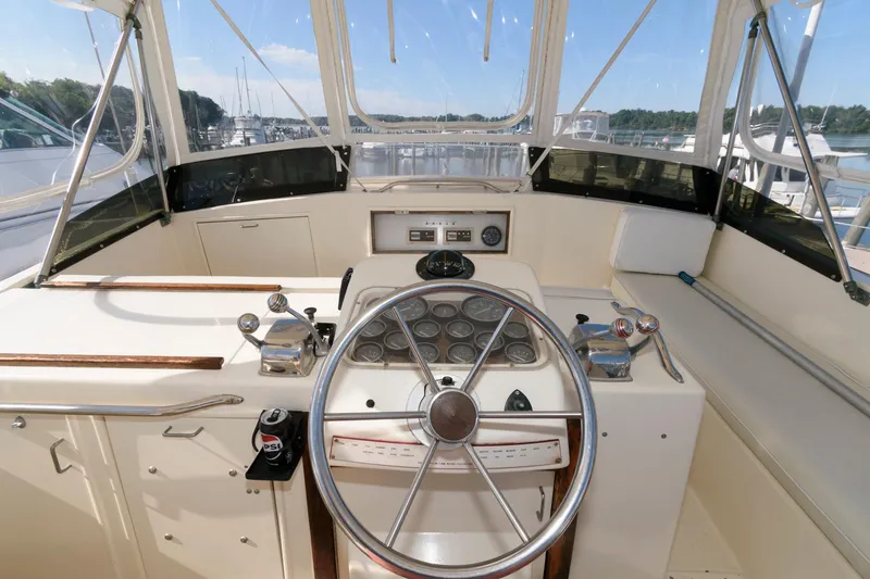 Slide: The Image of 1985 Ocean Yachts 46 Aft Cabin Motor Yacht helm with steering wheel and controls. - 11