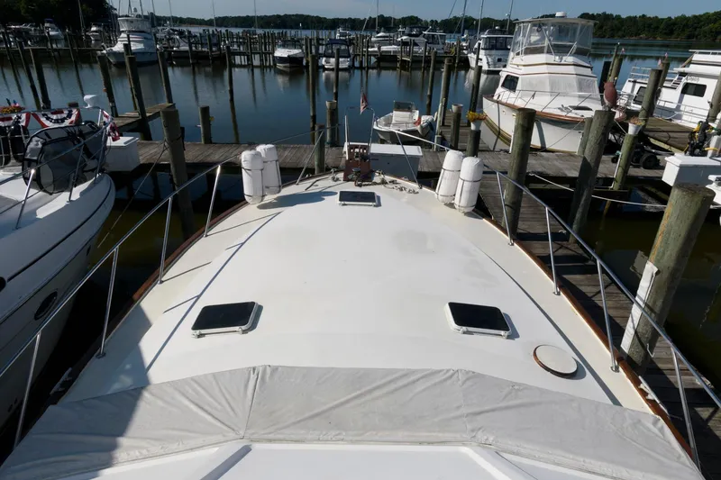 Slide: The Image of 1985 Ocean Yachts 46 Aft Cabin Motor Yacht docked at marina, surrounded by other boats. - 12