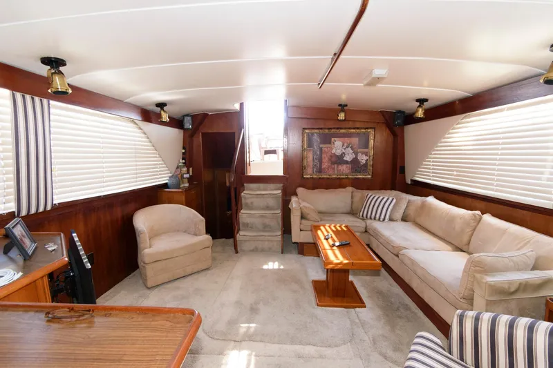 Slide: The Image of Interior of 1985 Ocean Yachts 46 Aft Cabin Motor Yacht, featuring cozy seating and elegant decor. - 16