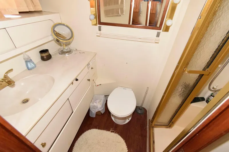 Slide: The Image of 1985 Ocean Yachts 46 Aft Cabin Motor Yacht bathroom with vanity, toilet, and shower. - 21
